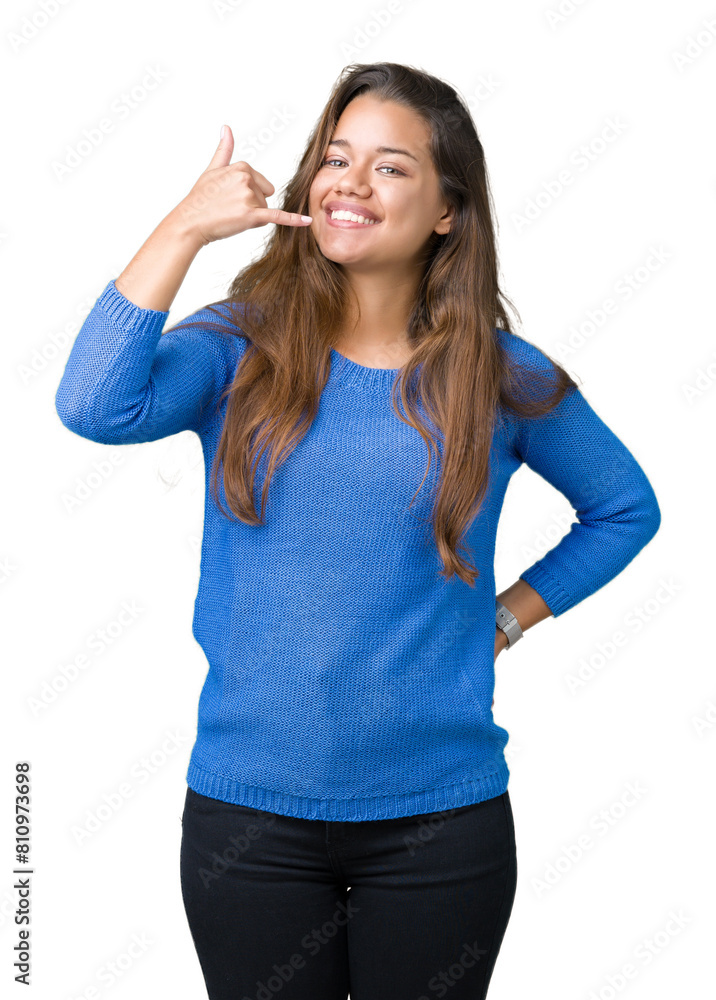 Young beautiful brunette woman wearing blue sweater over isolated background smiling doing phone gesture with hand and fingers like talking on the telephone. Communicating concepts. Young beautiful brunette woman wearing blue sweater over isolated background smiling doing phone gesture with hand and fingers like talking on the telephone. Communicating concepts.