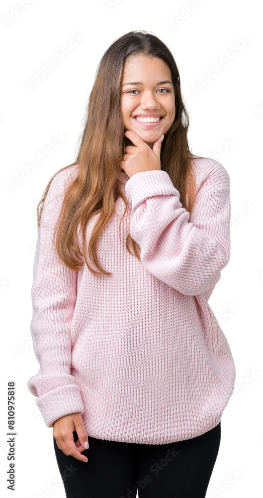 Young beautiful brunette woman wearing pink winter sweater over isolated background looking confident at the camera with smile with crossed arms and hand raised on chin. Thinking positive. Young beautiful brunette woman wearing pink winter sweater over isolated background looking confident at the camera with smile with crossed arms and hand raised on chin. Thinking positive.