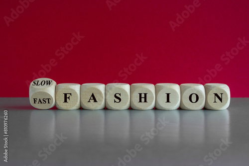 Obraz na płótnie Fast or slow fashion symbol. Cubes form the expression Fast fashion and Slow fashion. Beautiful grey table red background. Business fast or slow fashion concept. Copy space. w salonie