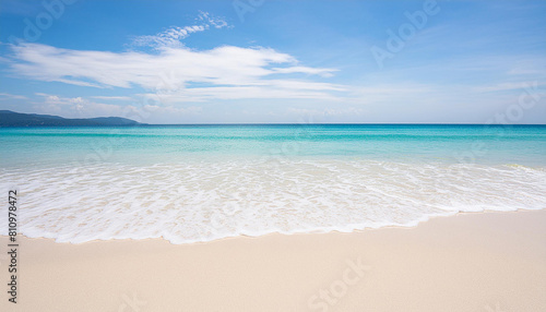 Beautiful Beach Background with Blue Water and White Sand. Serene Coastal Scene with Gentle Waves Rolling onto the Shore. Summer Vacation Destination with Pristine Beach.