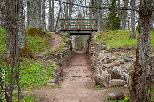 Walkway in the Burtnieku manor park. Pedestrian bridge creates two levels of pathways through the park. Latvia.