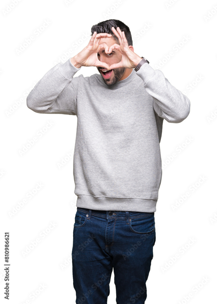 Young handsome man wearing sweatshirt over isolated background Doing heart shape with hand and fingers smiling looking through sign Young handsome man wearing sweatshirt over isolated background Doing heart shape with hand and fingers smiling looking through sign