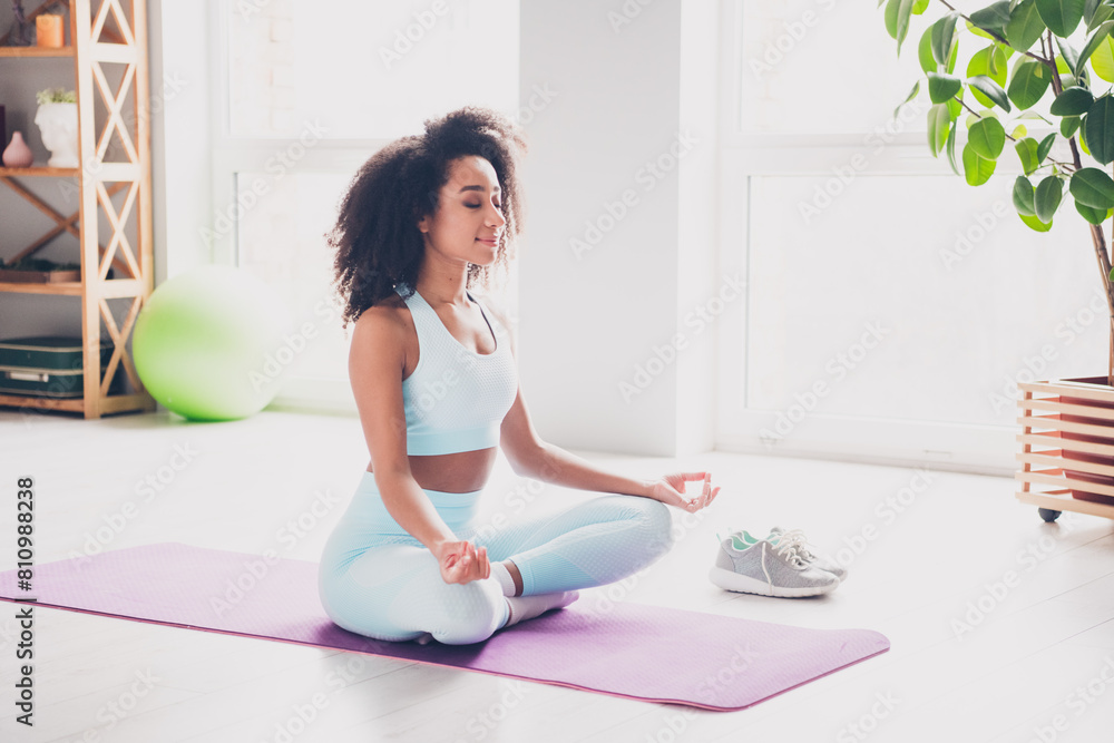 Full length photo of positive charming woman sportswear enjoying yoga indoors house apartment room Full length photo of positive charming woman sportswear enjoying yoga indoors house apartment room