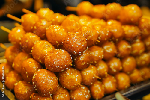 Fried sesame sweet sticky rice balls skewers - Tang You Guo Zi - Sichuan snack photo
