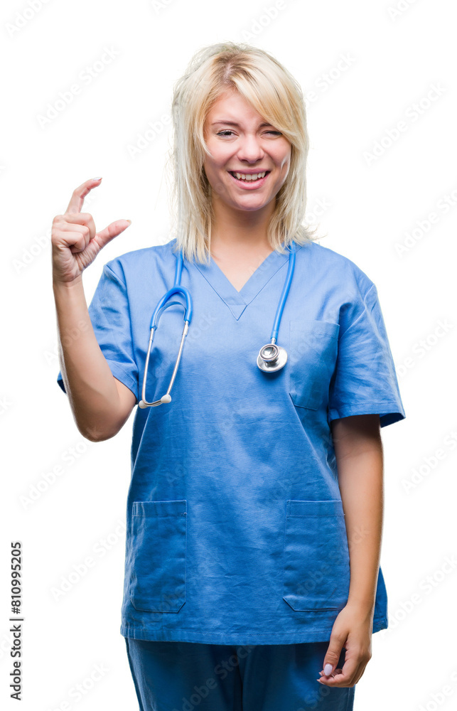 Young beautiful blonde doctor woman wearing medical uniform over isolated background smiling and confident gesturing with hand doing size sign with fingers while looking and the camera. Young beautiful blonde doctor woman wearing medical uniform over isolated background smiling and confident gesturing with hand doing size sign with fingers while looking and the camera.