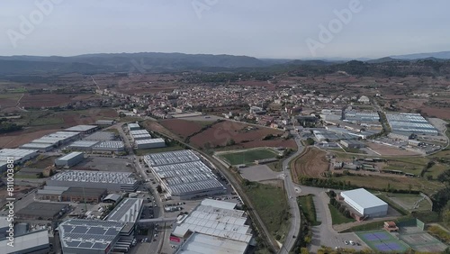 Aerial view of typical catalan village. Drone shot. Cloudy day in Spain, european culture. Small town in Barcelona near green fields and Montserrat mountain. photo