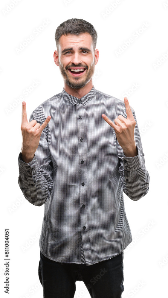 Young hipster man shouting with crazy expression doing rock symbol with hands up. Music star. Heavy concept. Young hipster man shouting with crazy expression doing rock symbol with hands up. Music star. Heavy concept.