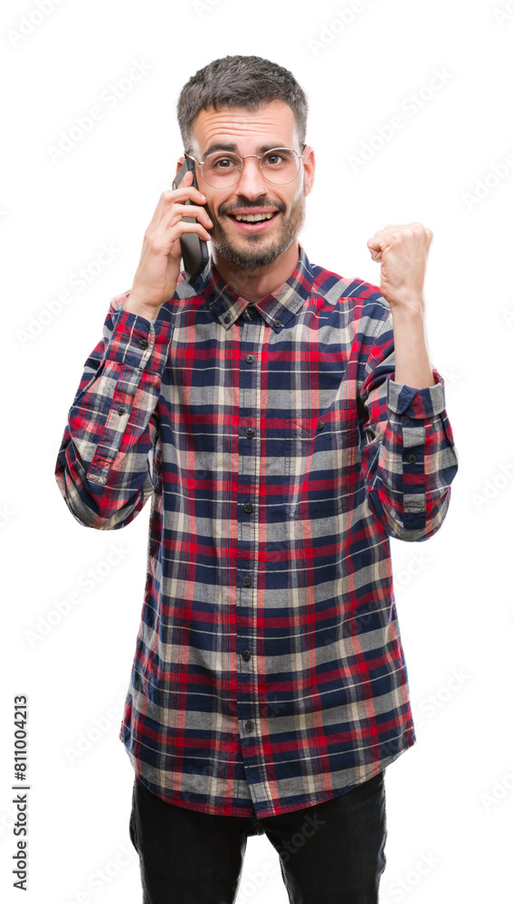 Young hipster adult man talking on the phone screaming proud and celebrating victory and success very excited, cheering emotion Young hipster adult man talking on the phone screaming proud and celebrating victory and success very excited, cheering emotion