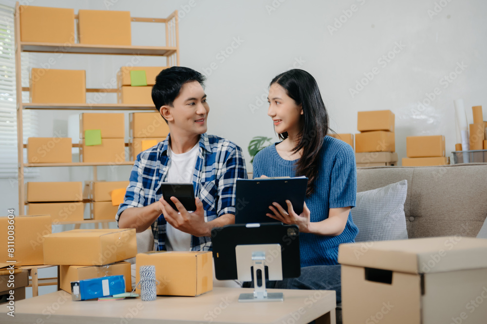 Startup small business SME, Entrepreneur owner man and woman using smartphone or tablet taking receive and checking online purchase shopping order Startup small business SME, Entrepreneur owner man and woman using smartphone or tablet taking receive and checking online purchase shopping order