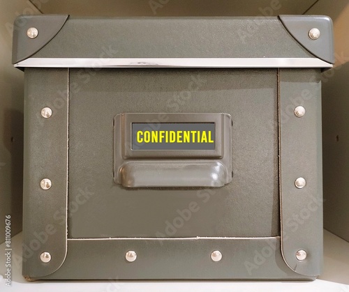 Document box with tag written CONFIDENTIAL, concept of data or information intended to be kept secret, secret or private, business or military top secret document