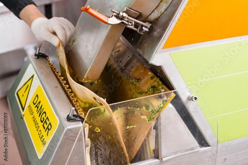 Close up crop shot of a juice lab where a person is handling a machine.
