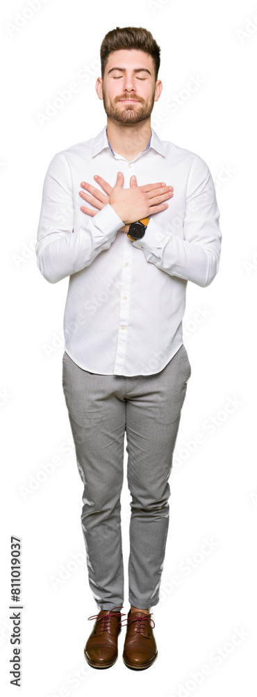Young handsome business man smiling with hands on chest with closed eyes and grateful gesture on face. Health concept. Young handsome business man smiling with hands on chest with closed eyes and grateful gesture on face. Health concept.
