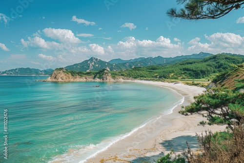 A picturesque scene of a tranquil beach with turquoise waters, framed by lush green mountains under a clear blue sky.