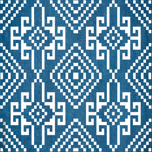 Pixel thai art on indigo dyed fabric background.