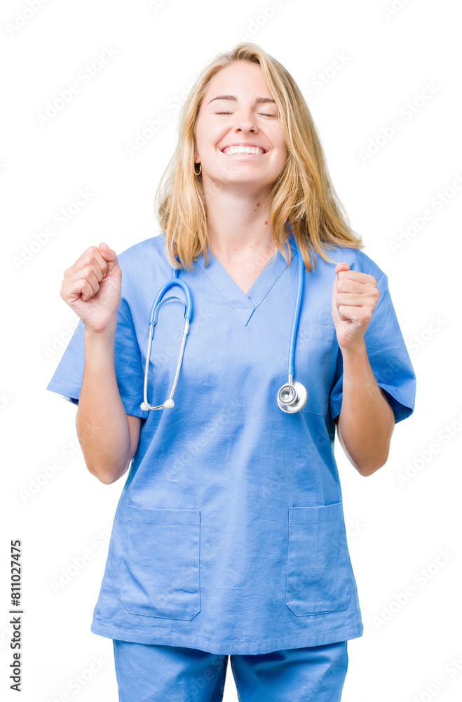 Beautiful young doctor woman wearing medical uniform over isolated background excited for success with arms raised celebrating victory smiling. Winner concept. Beautiful young doctor woman wearing medical uniform over isolated background excited for success with arms raised celebrating victory smiling. Winner concept.