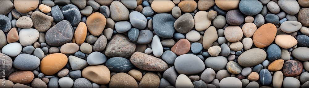 Generate a seamless texture of a pebble beach. The pebbles should be of various sizes and colors, and should be arranged in a random pattern.