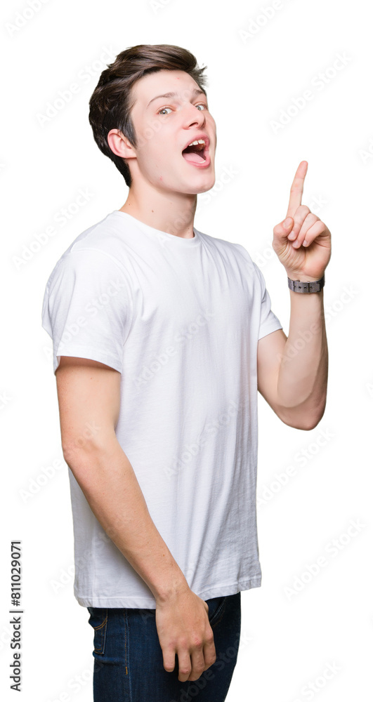 Young handsome man wearing casual white t-shirt over isolated background pointing finger up with successful idea. Exited and happy. Number one. Young handsome man wearing casual white t-shirt over isolated background pointing finger up with successful idea. Exited and happy. Number one.