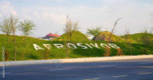Afrosiyob name written on a grassy hillside at the location of the remains of an ancient settlement in Samarkand, Uzbekistan photo
