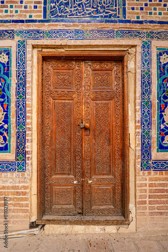 Carved wooden door in the Ulugh Beg Madrasah on the Registan Square in Samarkand, Uzbekistan photo