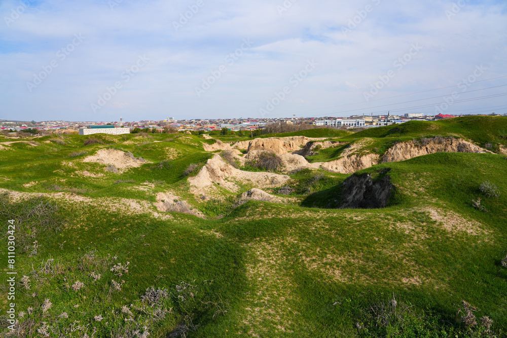 Fototapeta premium Afrasiyab (Afrosiyob) ancient settlement in ruins in Samarkand, Uzbekistan - Archaeological excavations on a grassy hill of Maracanda in Central Asia