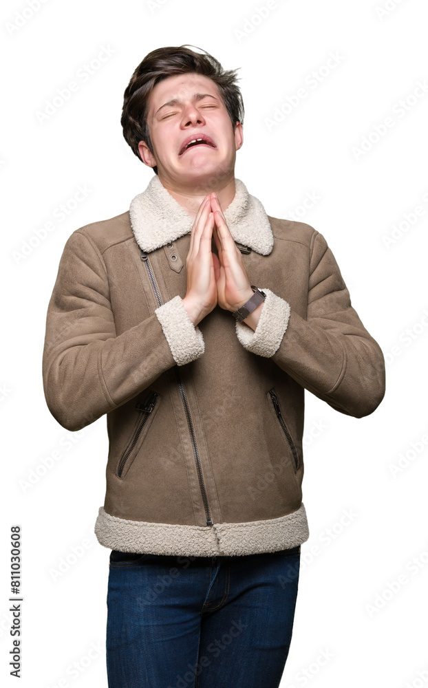 Young handsome man wearing winter coat over isolated background begging and praying with hands together with hope expression on face very emotional and worried. Asking for forgiveness. Young handsome man wearing winter coat over isolated background begging and praying with hands together with hope expression on face very emotional and worried. Asking for forgiveness.