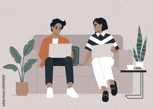 Casual Work Chat, Colleagues Collaborating on a Sofa in Modern Office, Two professionals engaged in a relaxed discussion with laptops on a comfortable couch