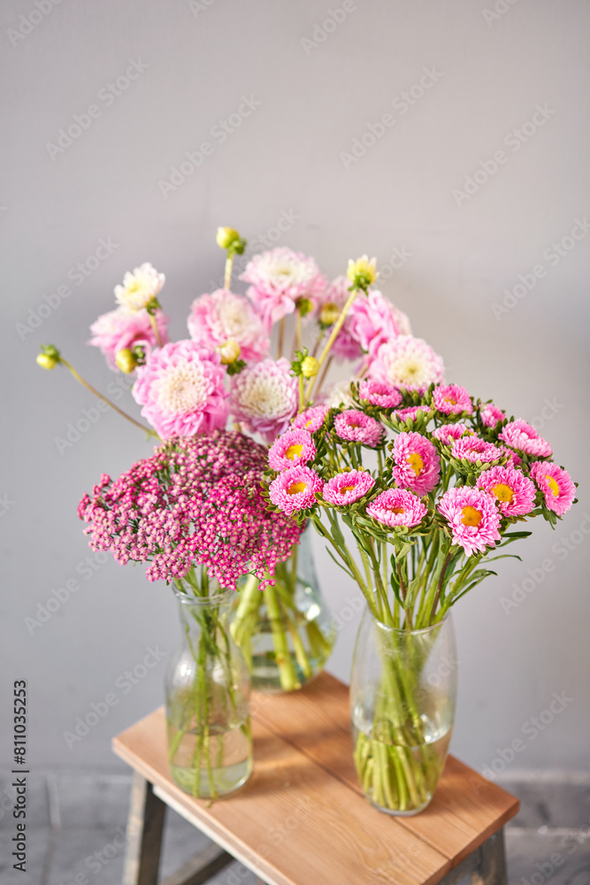 A bouquet of pink and white flowers in a vase on a table