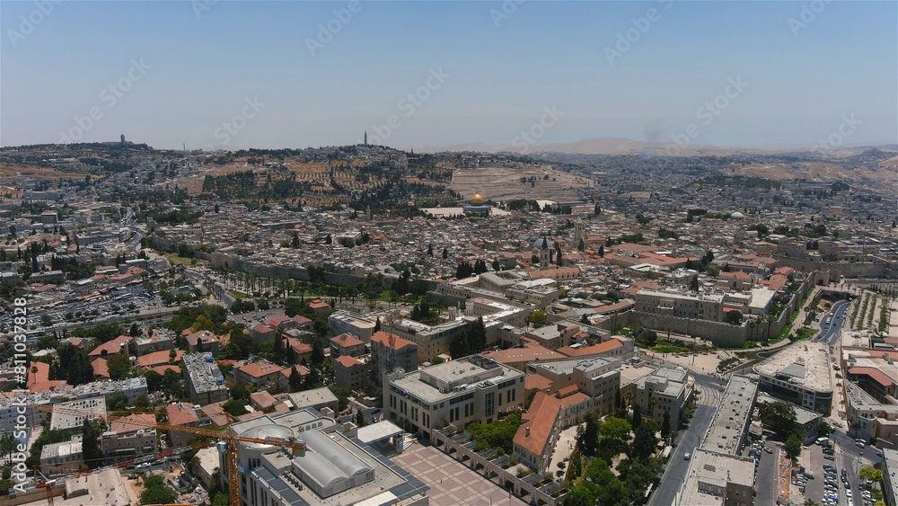 Fototapeta premium Jerusalem center city with red rooftops and tall buildings, drone view Drone view from center of Jerusalem at noon, israel, 2022 