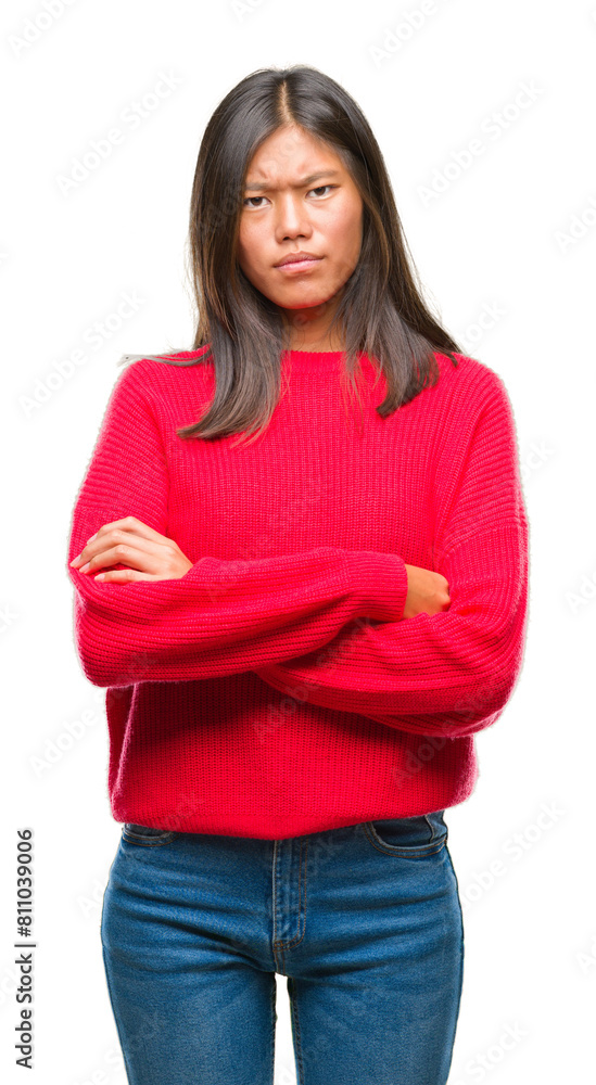 Young asian woman wearing winter sweater over isolated background skeptic and nervous, disapproving expression on face with crossed arms. Negative person. Young asian woman wearing winter sweater over isolated background skeptic and nervous, disapproving expression on face with crossed arms. Negative person.