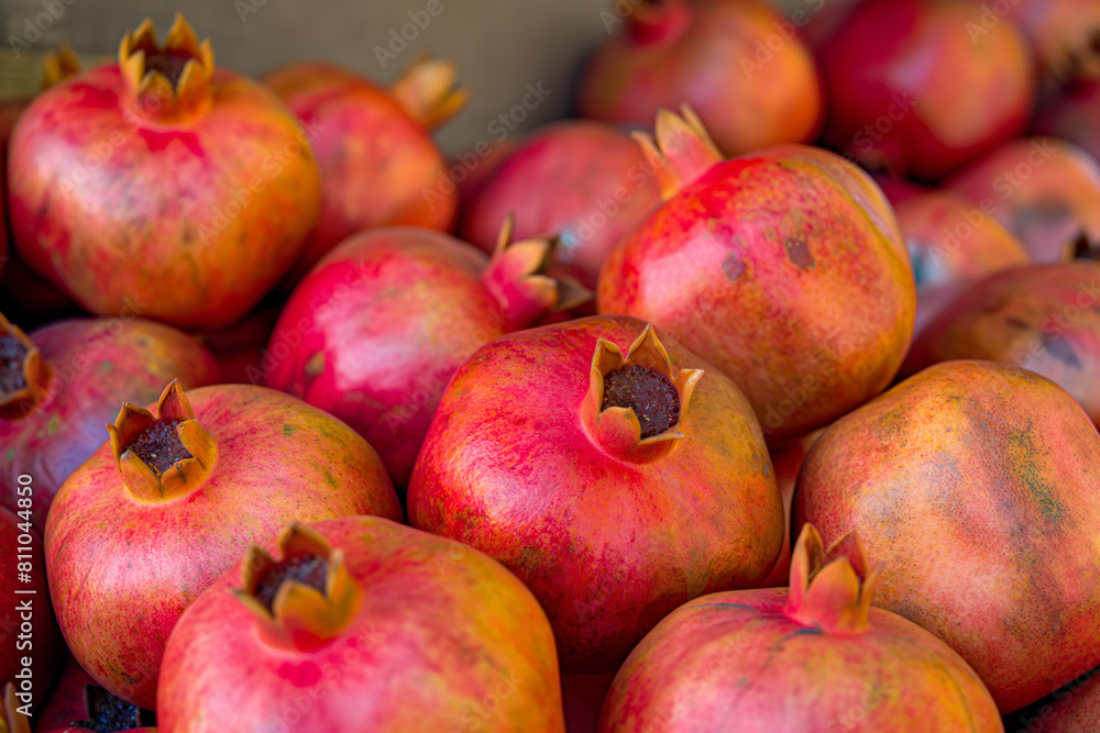 pomegranates on market, The pomegranates are arranged in a captivating display, their round shapes creating a sense of abundance and fertility pomegranates on market, The pomegranates are arranged in a captivating display, their round shapes creating a sense of abundance and fertility