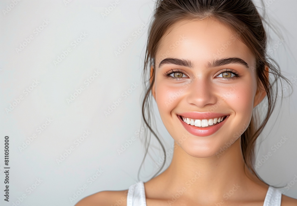 Close-up portrait of a young woman with sparkling eyes and a radiant, joyful smile. Close-up portrait of a young woman with sparkling eyes and a radiant, joyful smile.