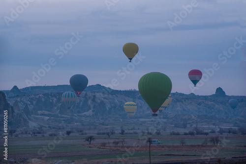 Sunrise in Cappadocia with colorful hot air balloons fly in sky over canyons, valleys morning tourist destination. Travel Turkey concept