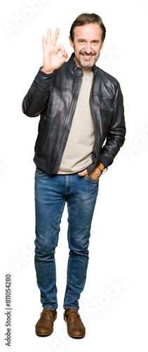 Middle age handsome man wearing black leather jacket smiling positive doing ok sign with hand and fingers. Successful expression. © Krakenimages.com