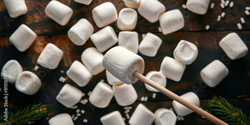 Sticks with delicious puffy marshmallows on black table.

