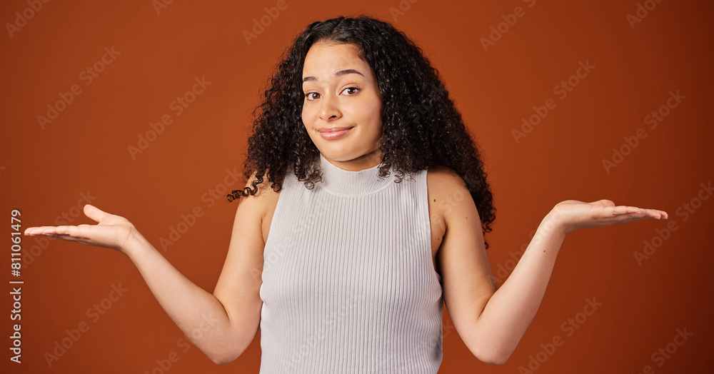 Portrait, woman and studio with comparison, choice and hand gesture on background with shrugging shoulders. Female person, options and doubt on backdrop in mockup space in indecision for alternatives Portrait, woman and studio with comparison, choice and hand gesture on background with shrugging shoulders. Female person, options and doubt on backdrop in mockup space in indecision for alternatives