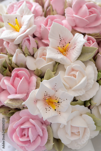 Zephyr bouquet of flowers in a wicker basket on a light background