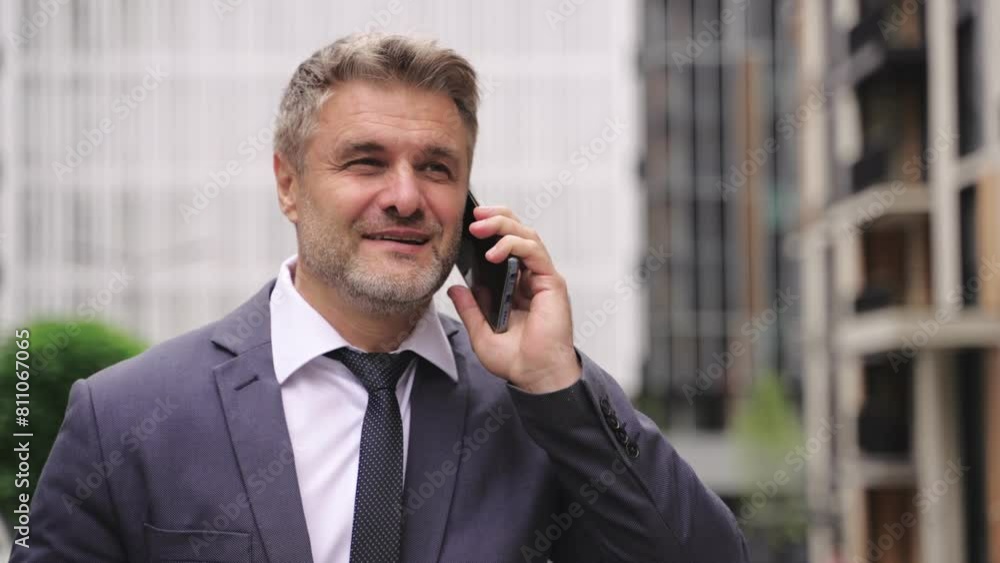 Happy businessman walking in the sitting and talking on the phone. Real time concept Happy businessman walking in the sitting and talking on the phone. Real time concept