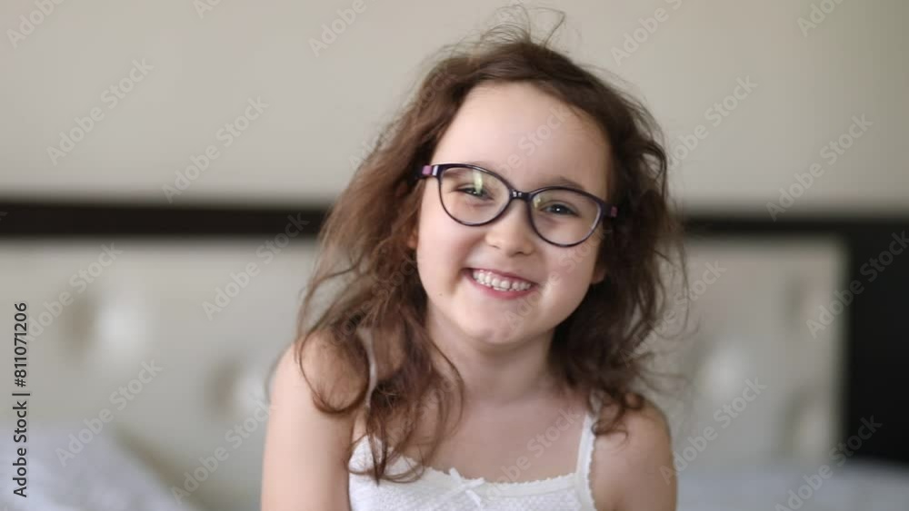 Cute little girl kid in glasses lens looking at camera and laughs. Cute little girl kid in glasses lens looking at camera and laughs.