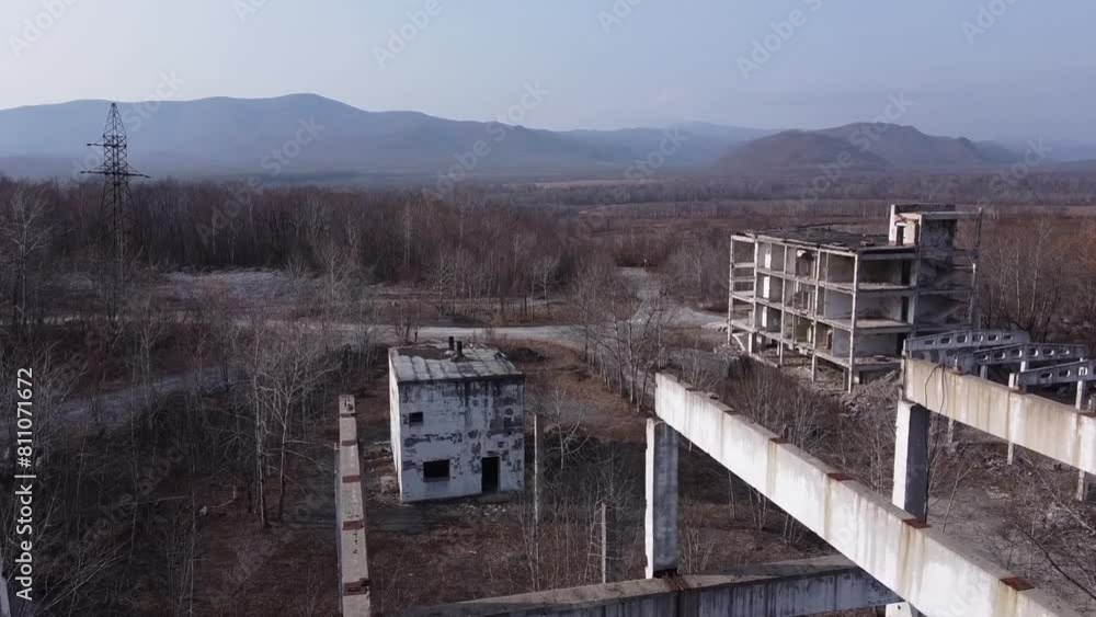 An eerie aerial view of a deserted building in a remote mountainous landscape An eerie aerial view of a deserted building in a remote mountainous landscape