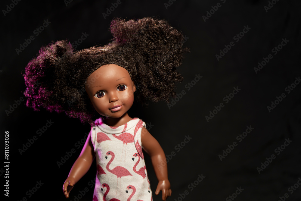 Dark skinned doll with curly hair wearing a flamingo pattern dress Dark skinned doll with curly hair wearing a flamingo pattern dress
