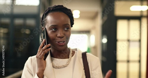 Professional African American Woman Smiling While Talking on Phone in a Modern Coworking Space photo