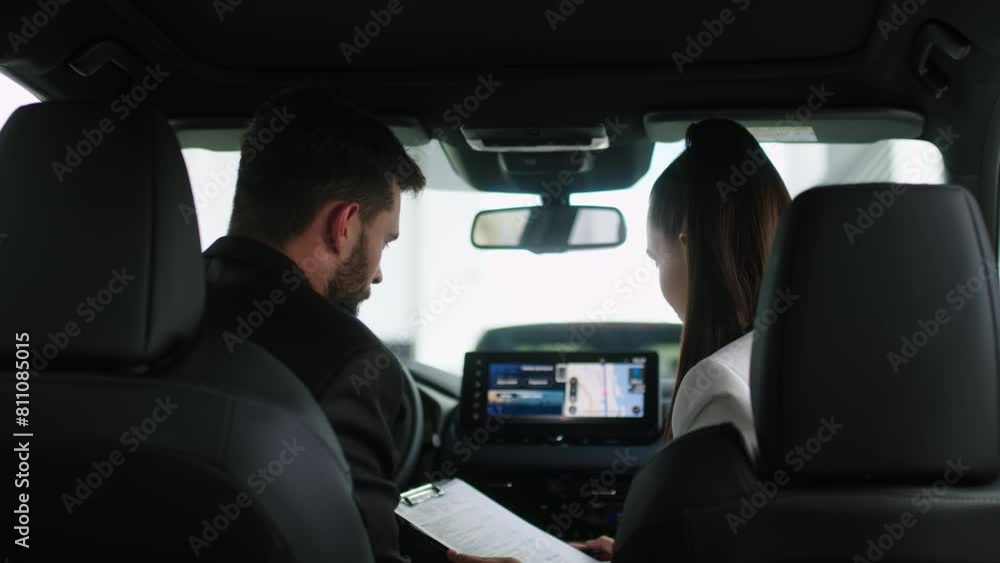 The buyer, a client of a modern car dealership, chooses a car. A dealer talks about a new model of a modern electric car. The concept of test drive, buying an electric car or renting it. The buyer, a client of a modern car dealership, chooses a car. A dealer talks about a new model of a modern electric car. The concept of test drive, buying an electric car or renting it.