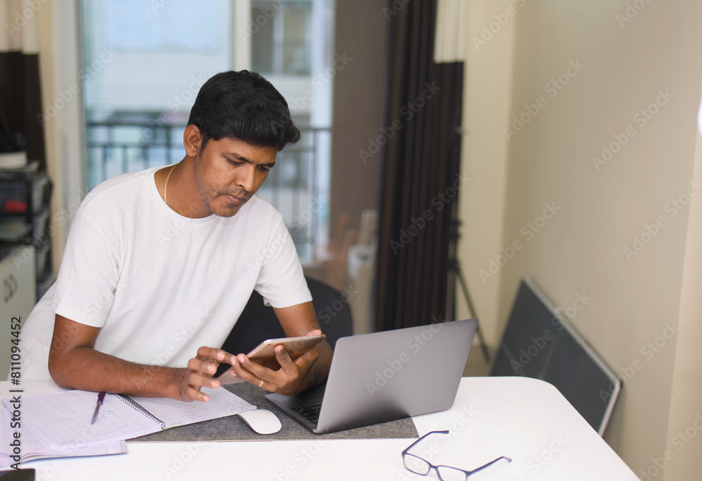 Young indian man working on laptop computer at home office Work from home concept Young indian man working on laptop computer at home office Work from home concept