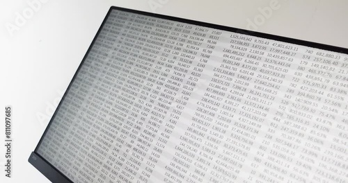 Spreadsheet scrolling downwards displayed on computer monitor at an angle