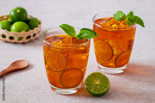 Iced tea with lime and mint leaf
