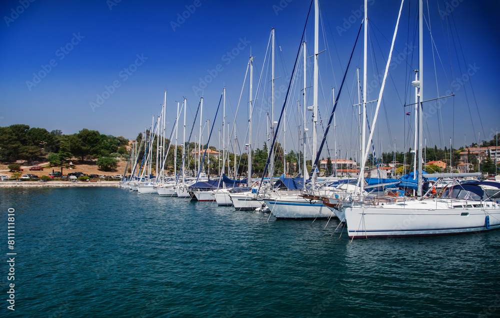 Obraz premium Coastal town and marina with boats and clear blue sky. European travel and vacation concept
