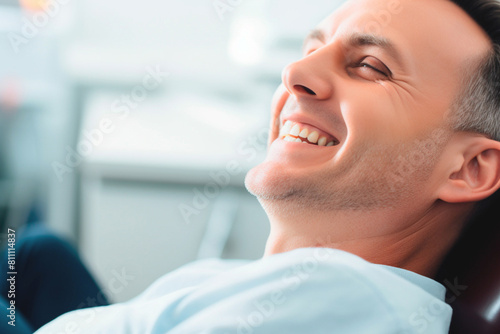 Sophisticated gentleman sporting well-maintained smile in dental room. Dental health plan photo