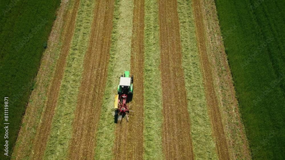 Heavy agricultural machinery in field. Tractor trims grass in agriculture field Heavy agricultural machinery in field. Tractor trims grass in agriculture field