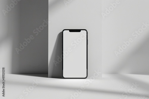 Mock-up of a blank iPhone screen on a flat surface, leaning against a wall.