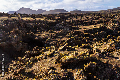 Trail around Cuervo volcano. "Malpais" - barren and stony field of lava. Cuervo volcano. Lanzarote, Canary Islands, Spain